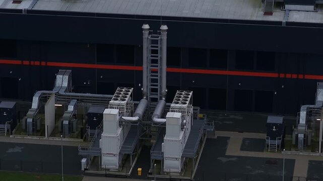 Close up aerial drone video of emergency backup generators at a large redundant data center in Middenmeer, The Netherlands, supporting big data storage, AI infrastructure,high performance computing.