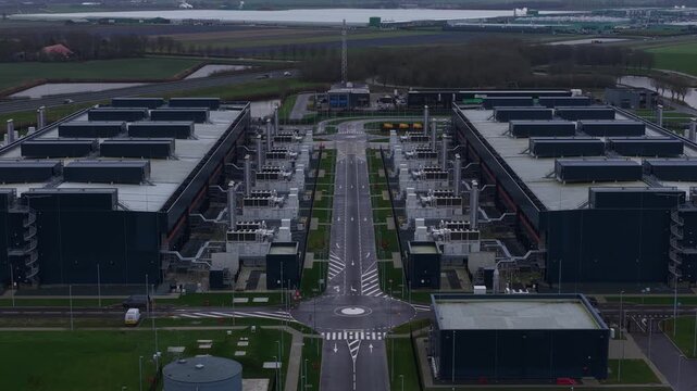 Aerial drone video of a large redundant colocation data center in Middenmeer, The Netherlands, showcasing massive data processing, storage capacity, and advanced AI computing infrastructure.