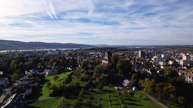 Aerial of a small green city with a lake in summer, Uster, Switzerland