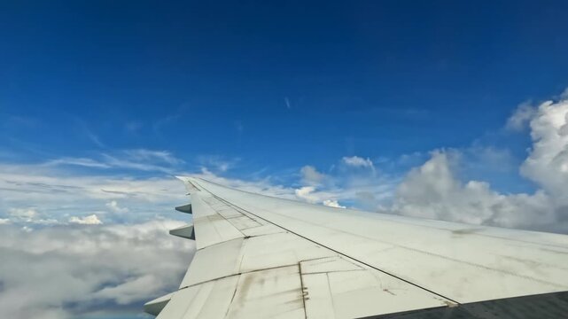 Plane cruising, wing view of emirates flight from Dubai to Seychelles, rainbow can be seen at the wing 25fps 007.