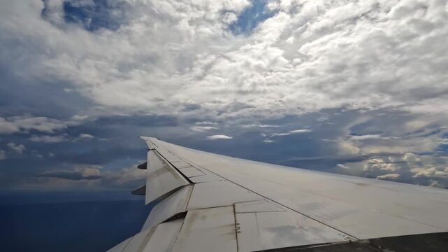 Plane starting the decent, wing view of emirates flight from Dubai to Seychelles, 25fps 010