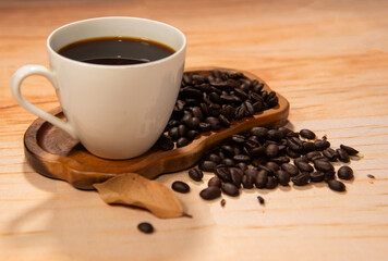 Coffee in a cup and beans on a stand