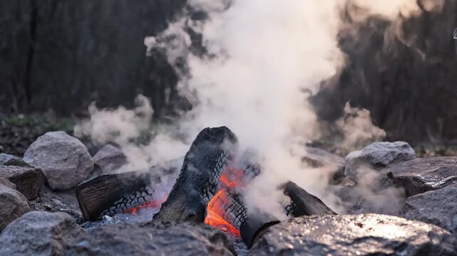 Outdoor Camping Fire with Water Pouring.