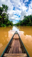 Obraz premium Boat navigating a calm river through lush green rainforest under a blue sky