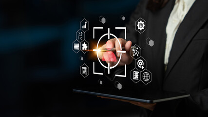 A business professional interacts with a digital touchscreen, showcasing data analysis icons and a target focus, symbolizing innovation and technology in contemporary work environments. Gantry