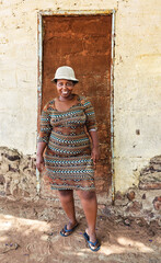 village happy african woman portrait, outdoors in the nature ,at home wall behind