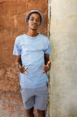 village happy african young man portrait, outdoors in the nature ,at home wall behind