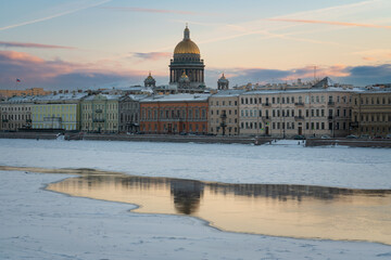 English embankment of the Neva and St. Isaac's Cathedral against the background of the dawn sky on...
