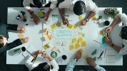 Top view of professional business team working together to brainstorm environmental idea by using...