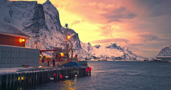 Fishermen, nets, fishing boat on arctic sea harbor, Lofoten Islands, Norway, Europe, Mountains hills and arctic fjords sunset landscape
