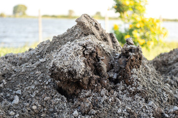 Soil bulk at that excavated at construction building site. Industrial working place, close-up and...