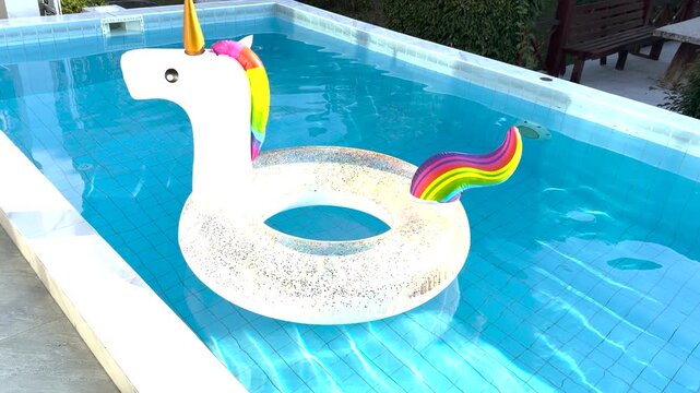 Colorful Unicorn Pool Float Gently Drifting in Sunlit Water