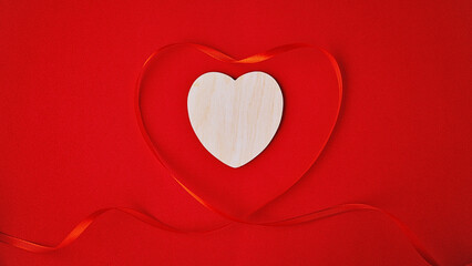 Romantic heart symbol with red ribbon on Valentine's Day background