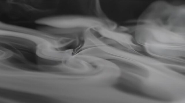 Extreme slow motion close-up of pure white mist gently swirling over a polished reflective surface creating serene patterns peaceful, liquid, conceptual