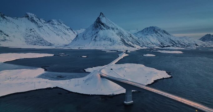 Aerial view Lofoten Islands, Norway panorama of Fredvang Bridge and nordic village, rocky sea shores and snowy mountains peaks spectacular landscape 