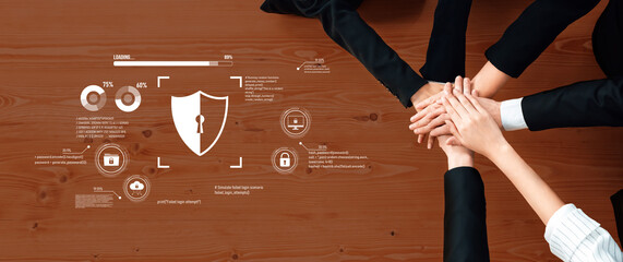 Hands together symbolizing teamwork and collaboration with digital security interface on wooden table highlighting protection and cybersecurity concepts Trope.