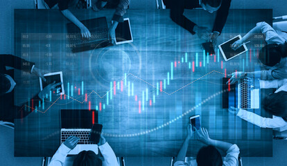 A team of diverse professionals collaborates in a modern office, utilizing technology to analyze financial data and stock charts, emphasizing teamwork and innovation. Scalp