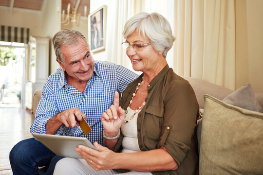 Elderly couple, tablet or credit card in home for ecommerce, app choice or retirement spending. Senior man, happy wife or technology in lounge with pointing, decision or discussion for investment