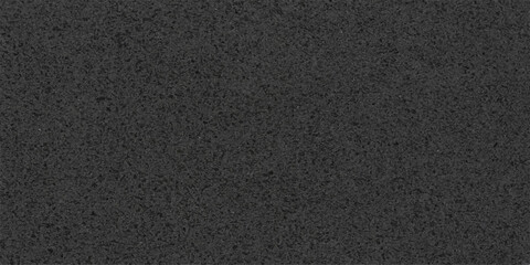 A rough dark asphalt street surface features a closeup pattern of textured black leather and fabric material with a grey stone tarmac backdrop for a construction detail wallpaper