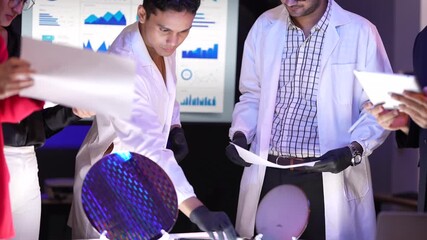 Research and development team collaborating on semiconductor manufacturing. Scientists and executives discussing the quality of a silicon wafer prototype in a modern high-tech facility. Professionals 