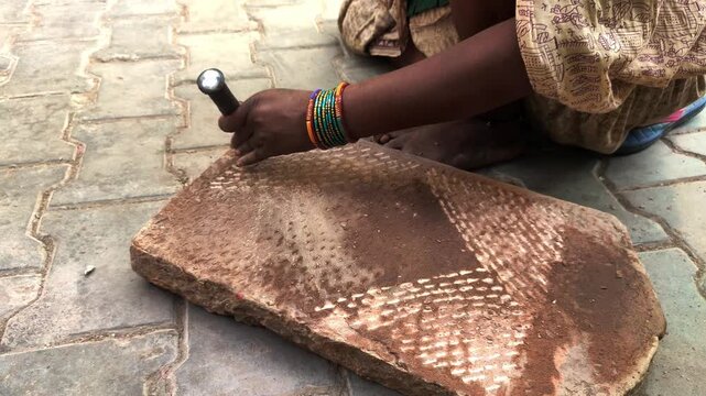 traditional stone grinder | women using a traditional grinding stone | traditional sil batta | worker using chisel and hammer on stone | female worker