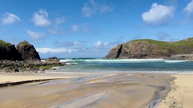 Timelapse of waves rolling onto Dalbeg Beach on the Isle of Lewis, Scotland, with blue sky and drifting clouds, capturing coastal motion, light, and Atlantic weather.