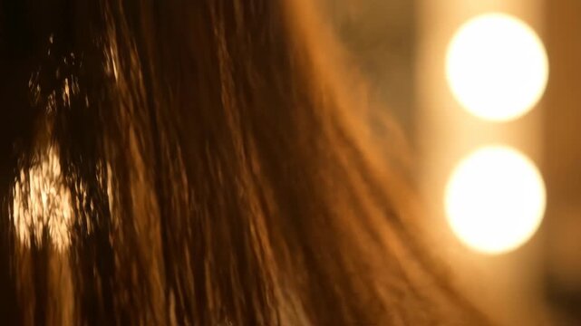 A close-up view capturing the flowing hair.  Warm light illuminates flowing hair, casting highlights, bokeh effects, glow