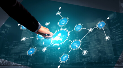 A businessman engages with a digital network interface, showcasing technology connections against an urban skyline, illustrating innovation and modern communication. Tessel