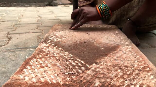traditional stone grinder | women using a traditional grinding stone | traditional sil batta | worker using chisel and hammer on stone | female worker