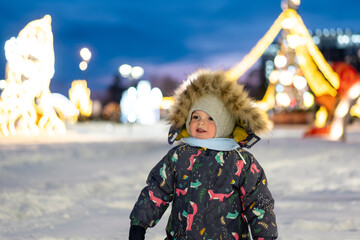 A cheerful young boy playing outside on New Year&rsquo;s Eve