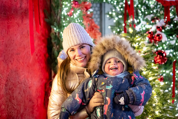 A cheerful mother and son playing outside on New Year&rsquo;s Eve