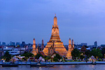Bangkok, Thailand - June 11, 2025: Evening view of tourists watching the sunset along the Chao Phraya River at Wat Arun.
