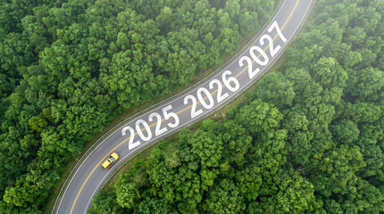 Aerial view of a winding road through a lush green forest with a yellow car driving on it, marked with the years 2025, 2026, 2027