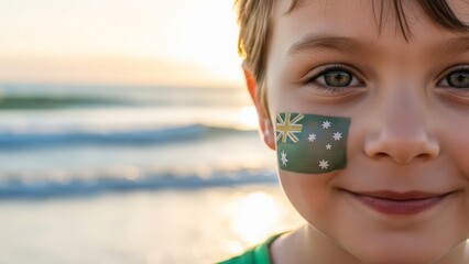 Young boy with Australian flag face paint smiles at the beach.