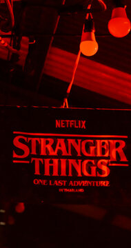 Netflix Stranger Things sign glows red. One Last Adventure in Thailand. Dark, moody atmosphere. Slow motion concept Vertical. Bangkok, Thailand, 23 Dec 2025