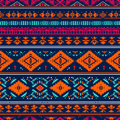 Vibrant seamless tribal ethnic pattern with geometric ornaments on dark blue background
