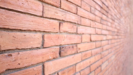 Old red brick wall. Red brick wall perspective view with selective focus.