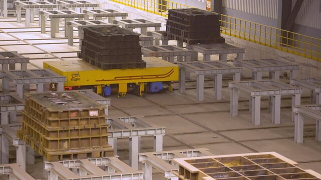 Industrial Factory Assembly Floor with Yellow Overhead Crane and Metal Parts