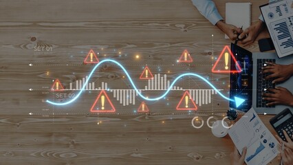Aerial view of a business meeting focusing on financial analysis with risk indicators, charts, and collaboration in a modern office, showcasing teamwork and strategy. Raster