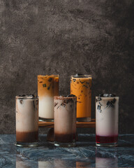 Assortment of Layered Drinks in Glasses.