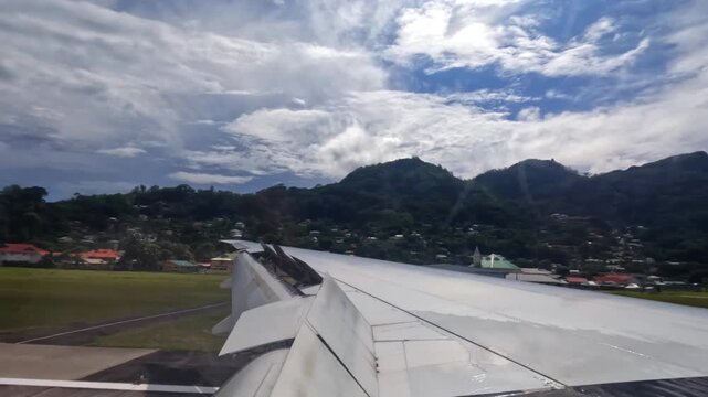 Plane touch down on Mahe island, wing view of emirates flight from Dubai to Seychelles, 25fps 012.