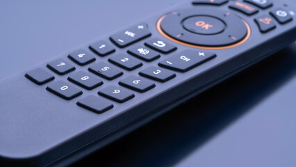 Modern TV remote control on a black background with reflection. Premium TV remote control. professional photo of the TV remote control. High quality photo