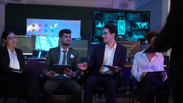 Corporate technology meeting in a modern office. Strategic team analyzing software code and market data displayed on large monitoring screens. Professionals discussing digital transformation and IT so