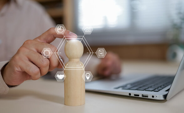 Human resource and team management concept with businessman holding digital team icon, representing employee data system, workforce management, business connection, leadership and talent analytics.