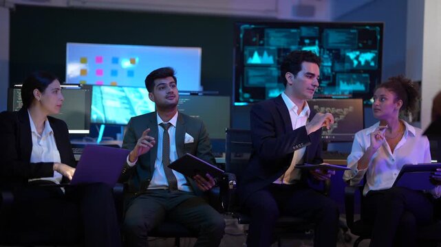 Corporate technology meeting in a modern office. Strategic team analyzing software code and market data displayed on large monitoring screens. Professionals discussing digital transformation and IT so