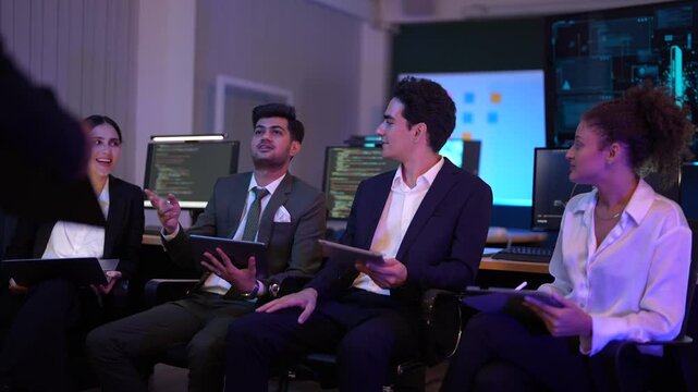 Corporate technology meeting in a modern office. Strategic team analyzing software code and market data displayed on large monitoring screens. Professionals discussing digital transformation and IT so