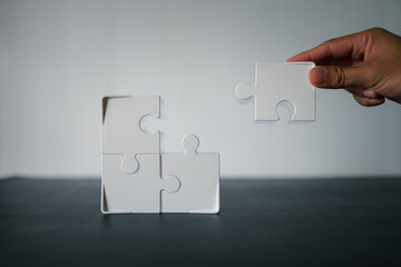 Business person solving a jigsaw puzzle 
