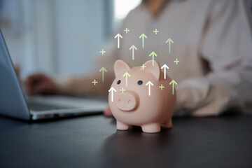 Saving and low-risk investment concept with hand putting coin in piggy bank and green growth chart. Ideal for stable returns, personal finance, long-term savings, and financial planning.