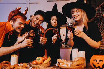Friends enjoying a Halloween party at a bar making a toast