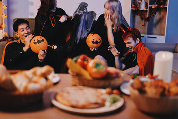 Friends enjoying a Halloween party at a bar making a toast